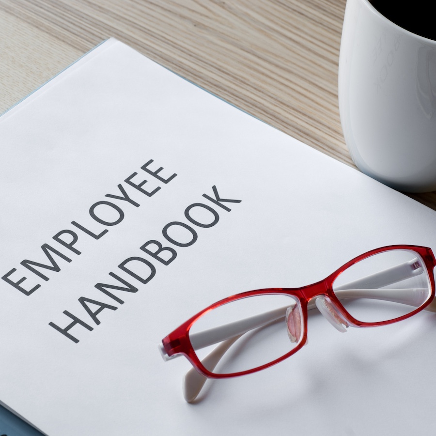 employee handbook with a pair of glasses on it
